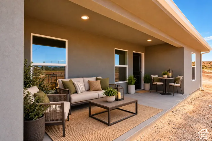 Covered patio with recessed lighting, multiple windows, and a black exterior door