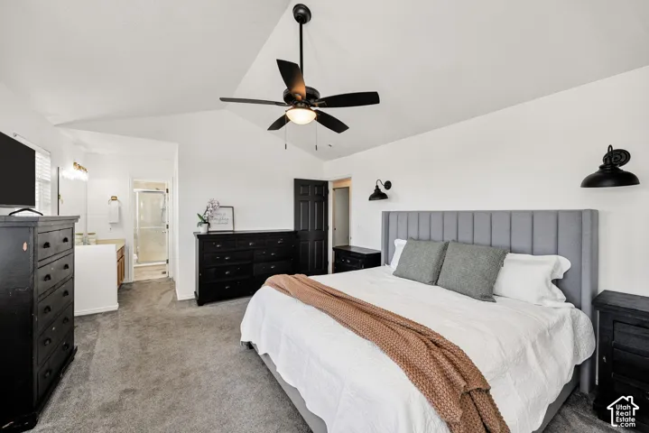 Ensuite vaulted ceiling with a ceiling fan, plush carpeting, built-in vanity.