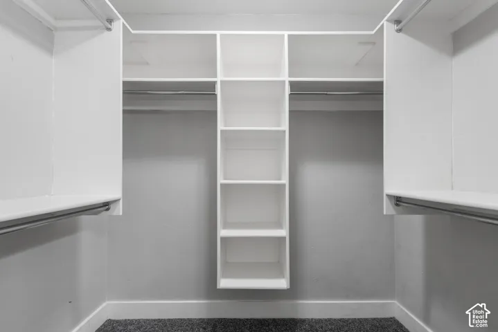 Built-in closet system featuring white shelving and hanging rods