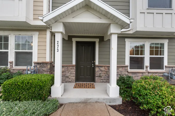 Covered entry with stone veneer and horizontal siding