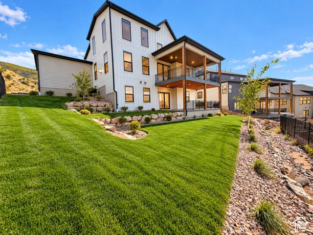 Two-story dwelling with white vertical siding and black trim windows. Lighting enhanced with ai.