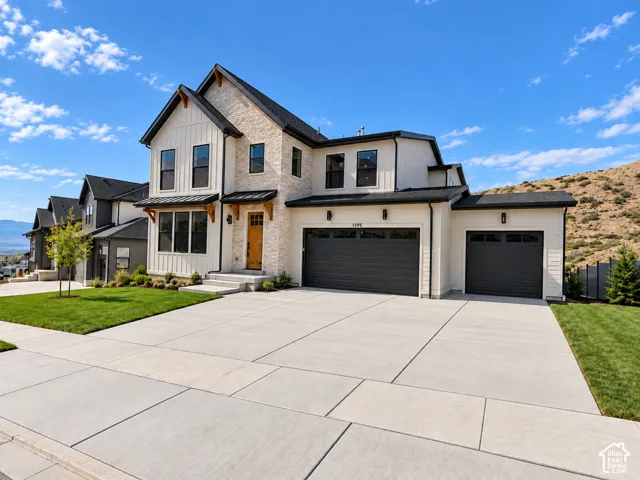 Modern exterior featuring a board and batten facade, stone accents, two-car and single-car garages, and a concrete driveway. Lighting enhanced with ai.