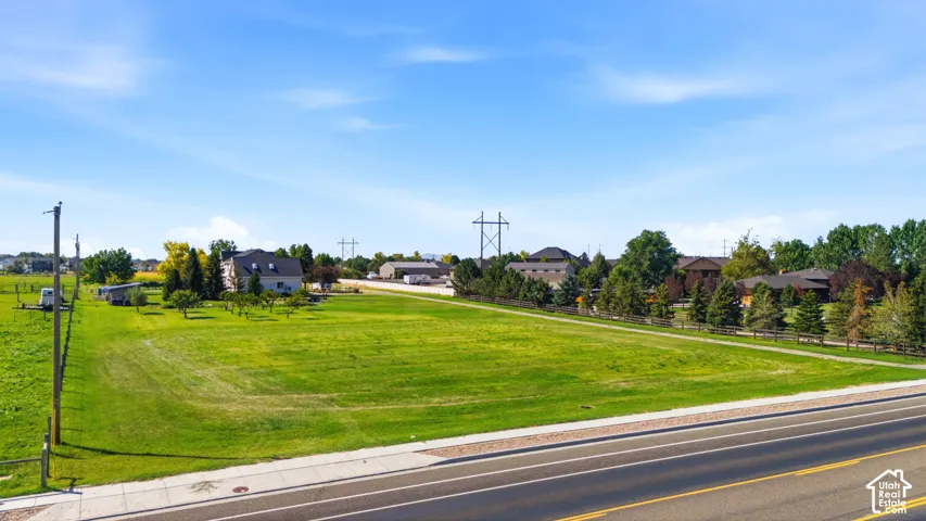 Expansive green lot with established landscaping and mature trees