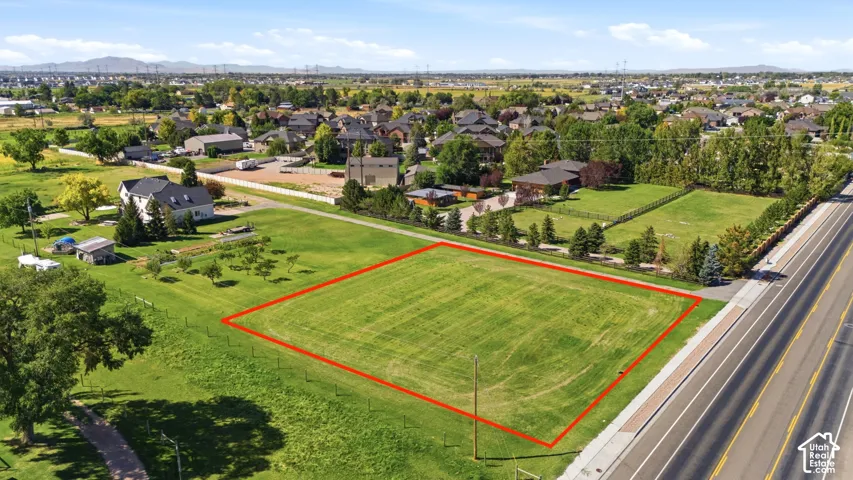Expansive lot featuring a grass field and bordering road access