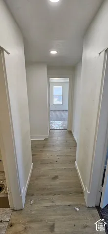 Recessed ceiling lighting illuminating wood-finish flooring