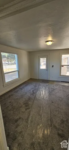 Gray textured carpeting, white walls, and bright overhead lighting