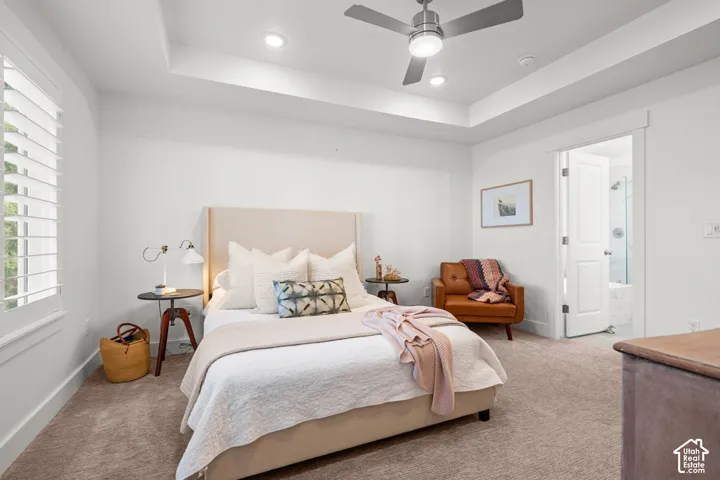 Tray ceiling featuring recessed lighting and a ceiling fan