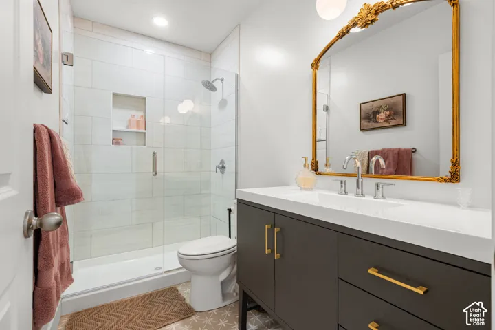 Walk-in shower with clear glass enclosure and tile surround