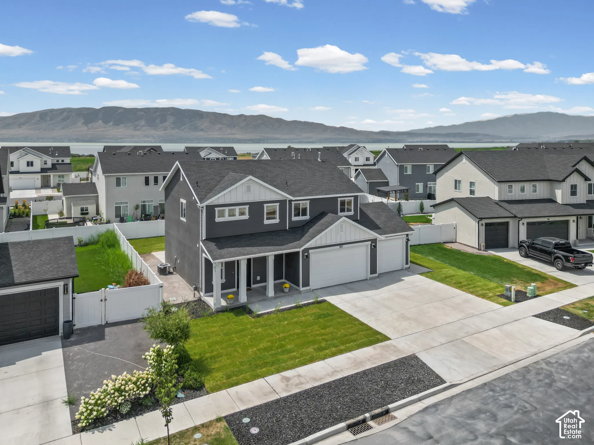Two-story residence with a two-car garage, concrete driveway, and front yard with green lawn