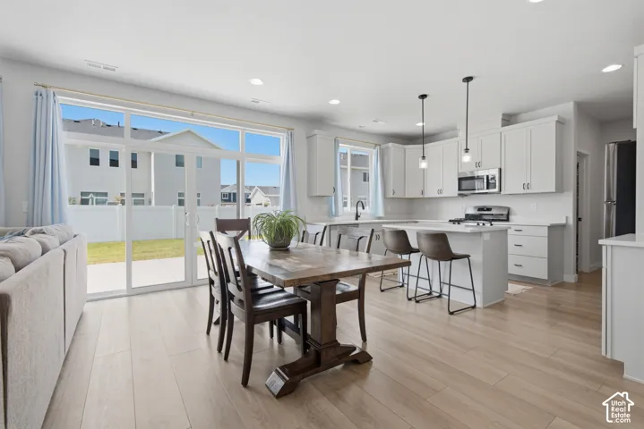 Spacious open-concept interior with light wood-finish flooring