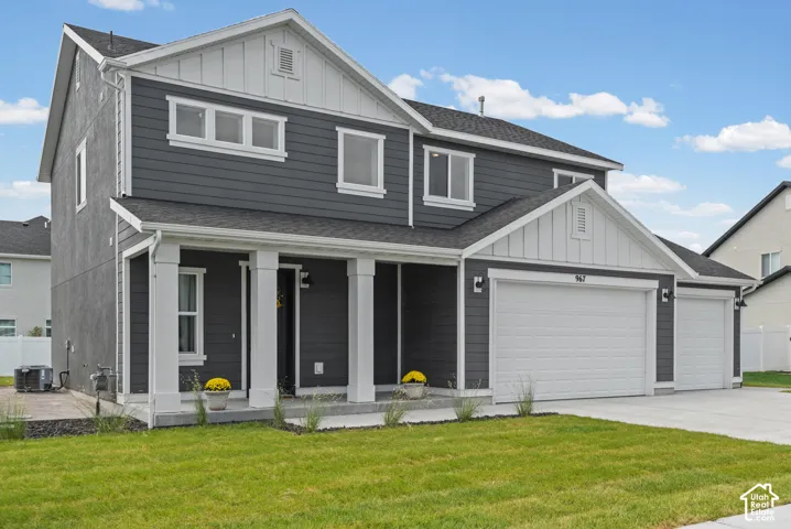 Two-story exterior with dark gray siding and white trim accents