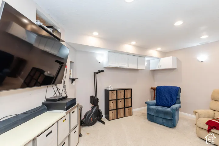 Recessed lighting, wall-mounted cabinetry, wall sconces, and built-in shelving