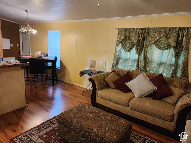 Wood-finish flooring throughout, with a built-in breakfast bar featuring a paneled base and stone-finish countertop