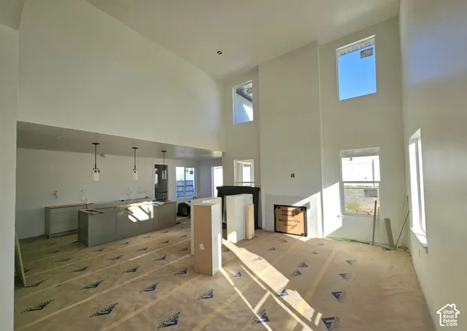 Soaring ceilings with upper-story windows, recessed lighting, and a built-in fireplace