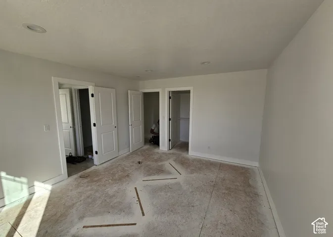 Recessed ceiling lighting, white interior doors, white trim, and light-colored walls