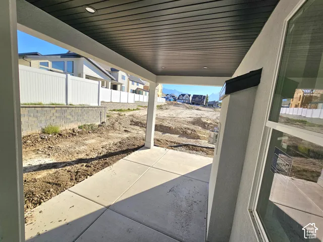 Covered patio with recessed lighting, concrete slab, and stucco exterior