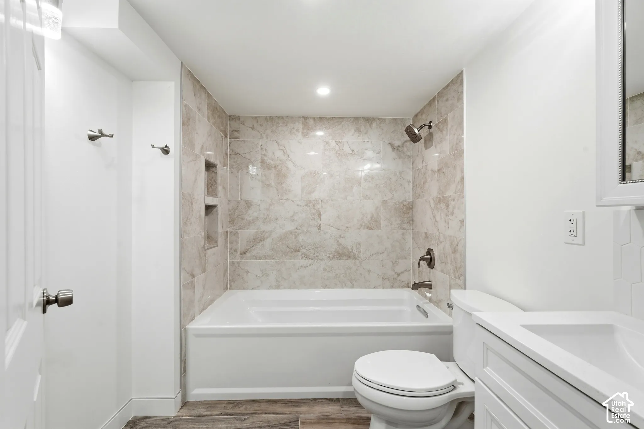 Tub and shower combination with tile surround and recessed shelving