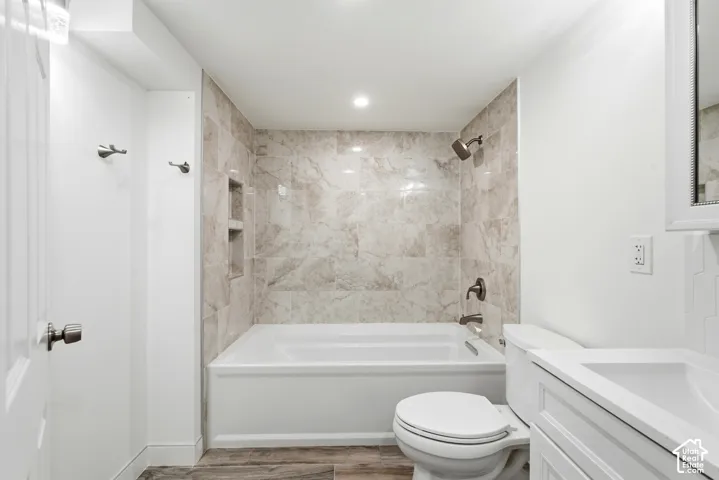 Tub and shower combination with tile surround and recessed shelving