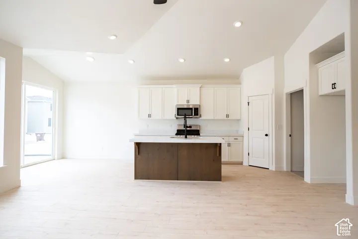 Open dining area adjacent to kitchen and 8' sliding glass door.
