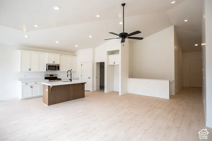 Terrific kitchen with 42" uppers, painted white wood cabinets, stained wood island, quartz slab countertops, gas range, microwave, dishwasher and disposal.