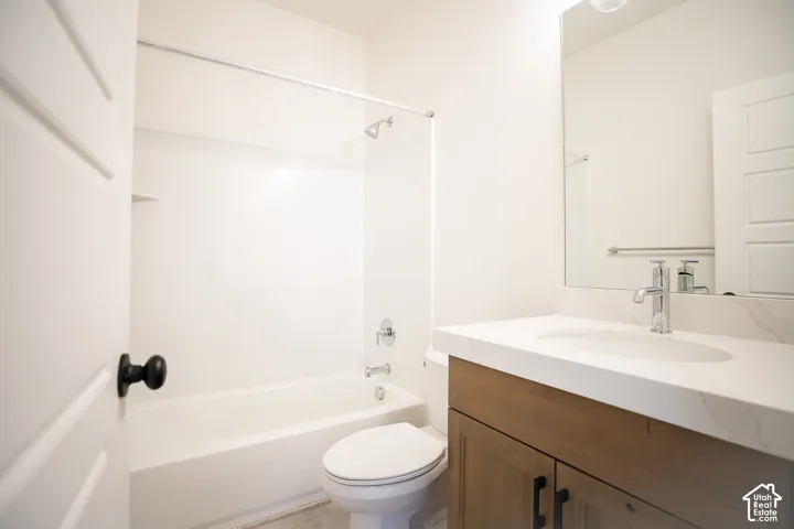 Full secondary bath with stained wood cabinet, quartz slab countertops.