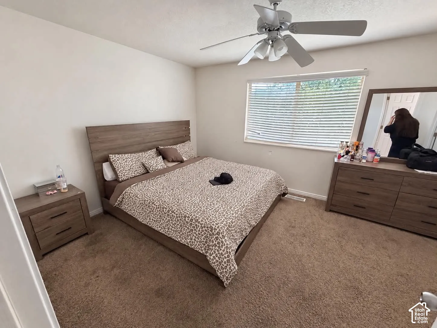 Ceiling fan with integrated lighting, window with horizontal blinds, neutral wall paint, and carpet flooring