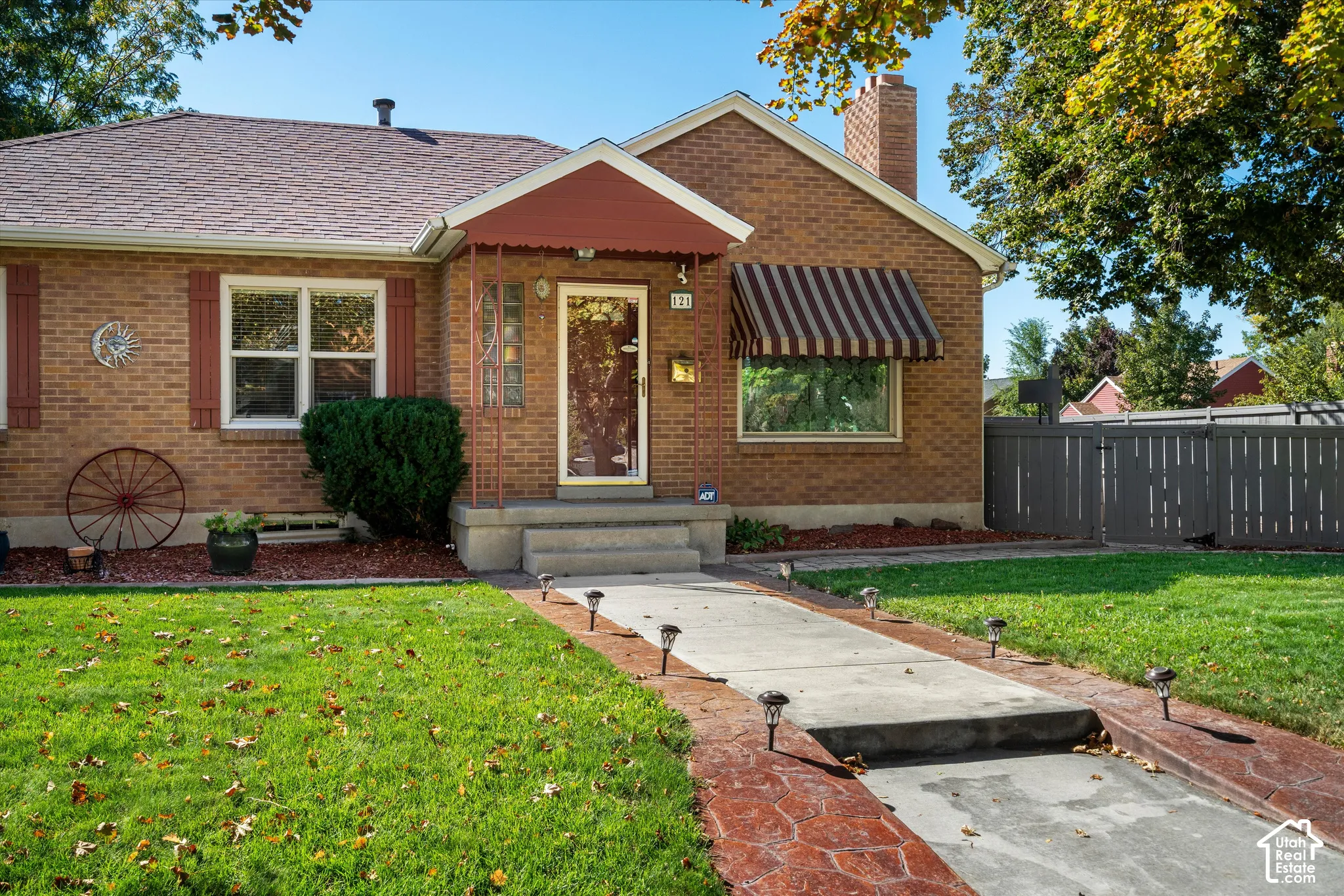 Brick exterior with a shingle roof and a covered entryway