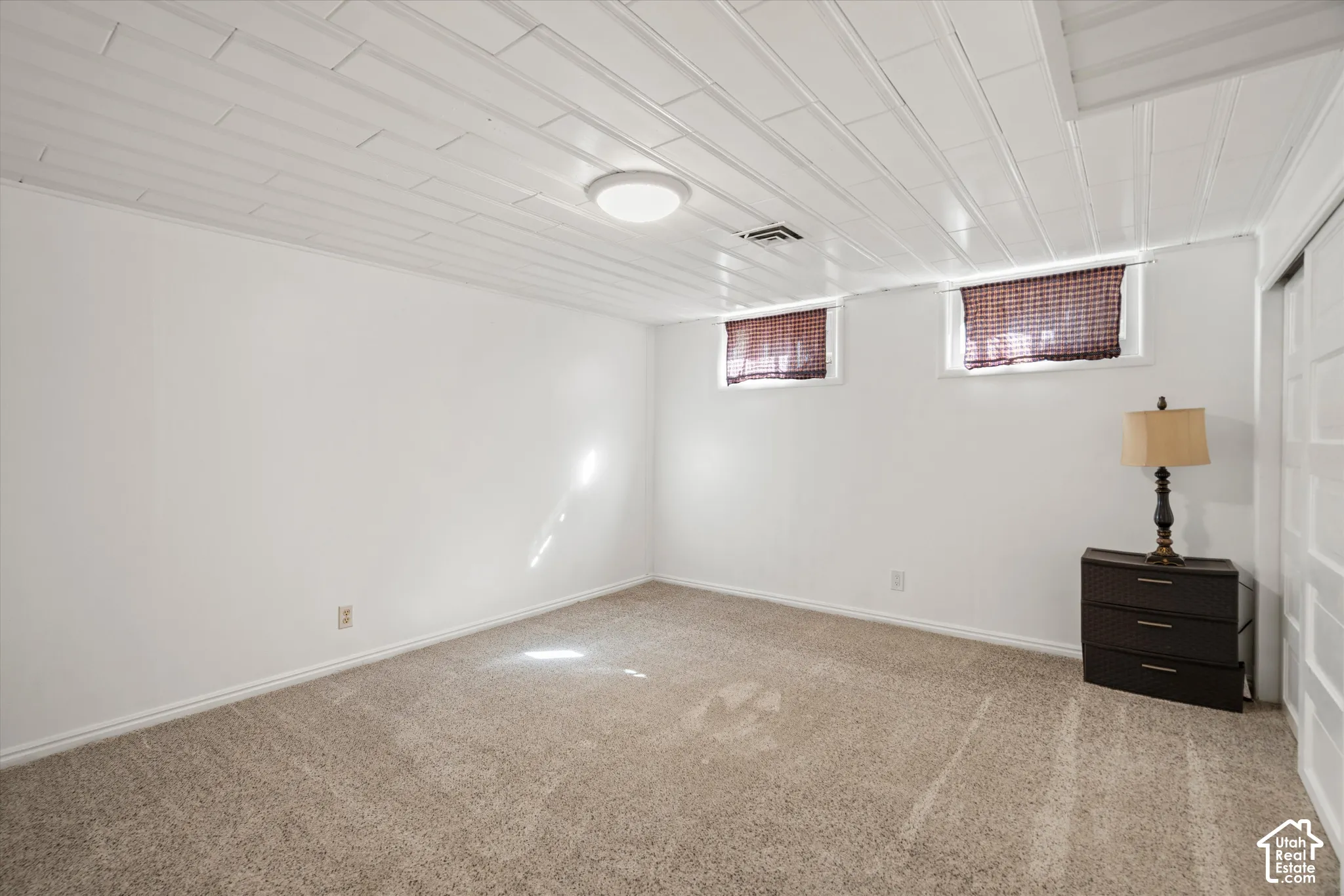 Plank-paneled ceiling with an attached flush-mount light fixture