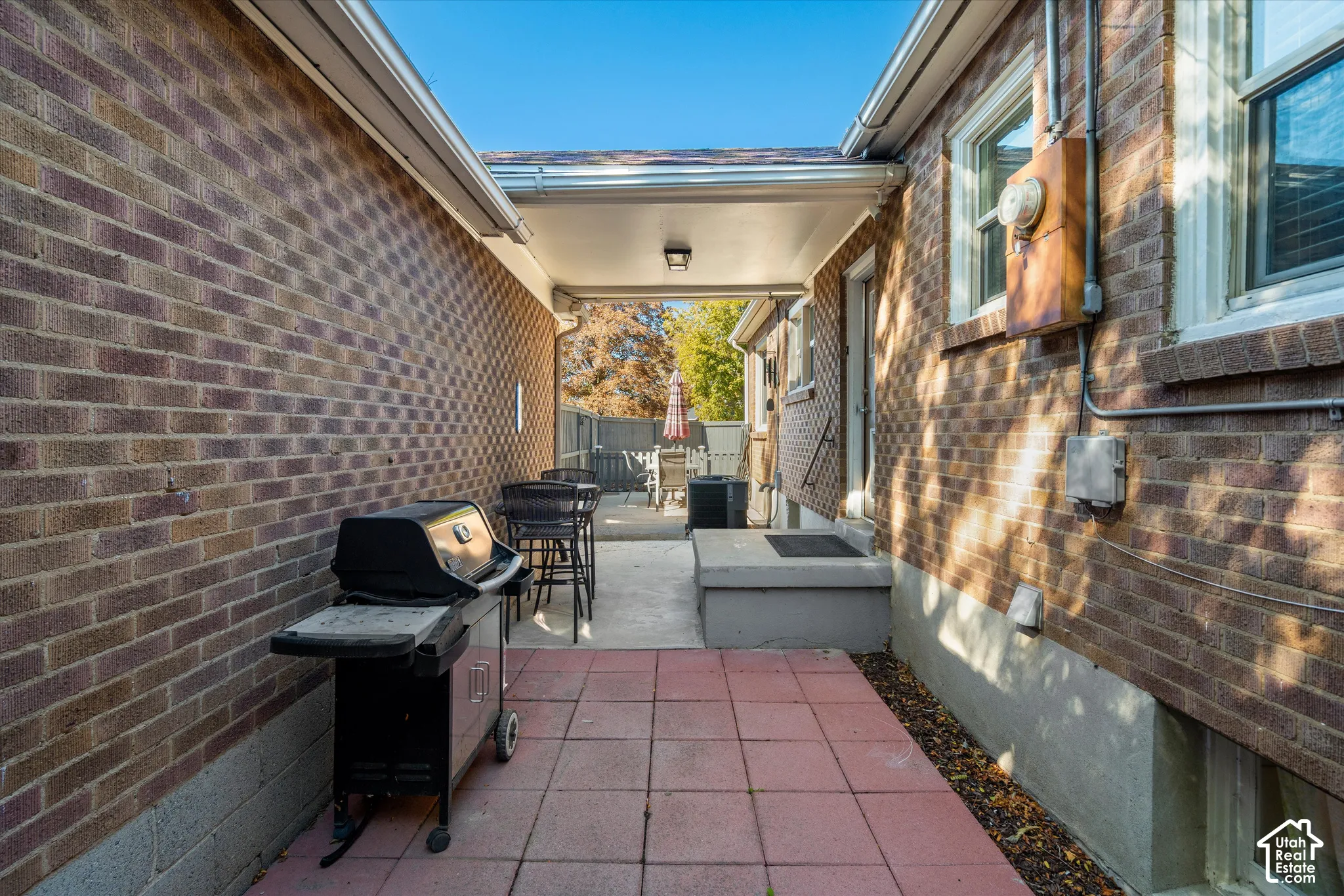 Covered patio with concrete and paver flooring