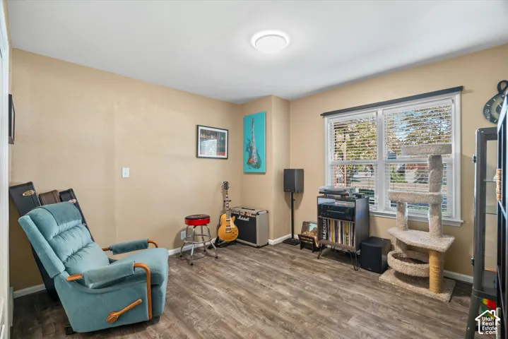 Wood-finish flooring with neutral wall tones and a window with blinds