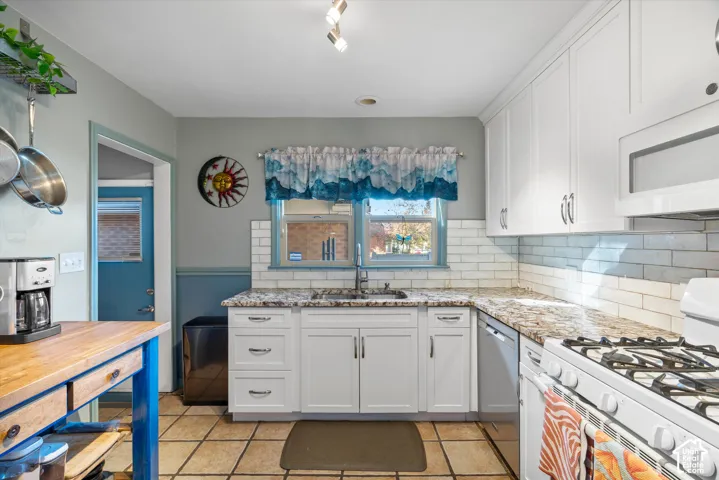 White cabinetry and subway tile backsplash