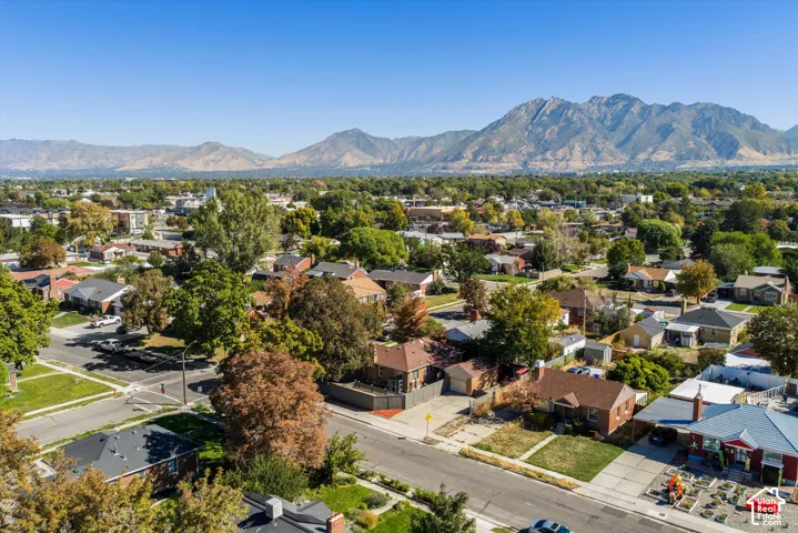 Residential neighborhood with mature trees and mountain scenery
