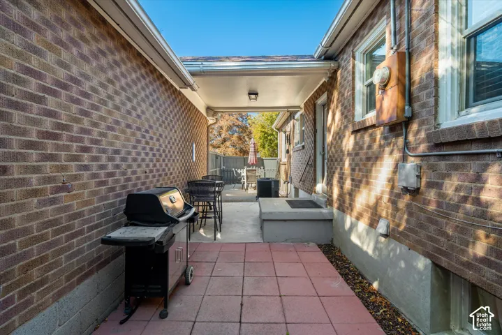 Covered patio with concrete and paver flooring