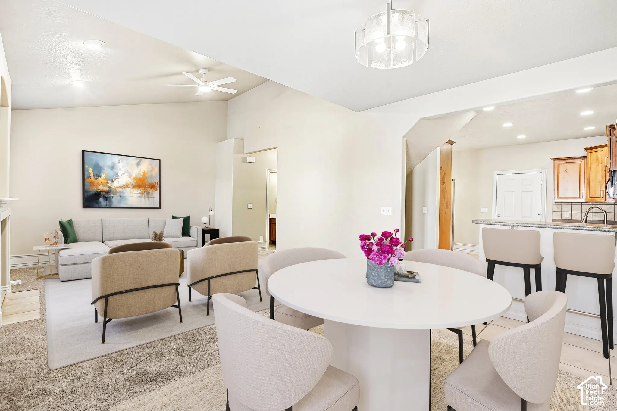 Vaulted ceiling with ceiling fan, recessed lighting, and a contemporary chandelier