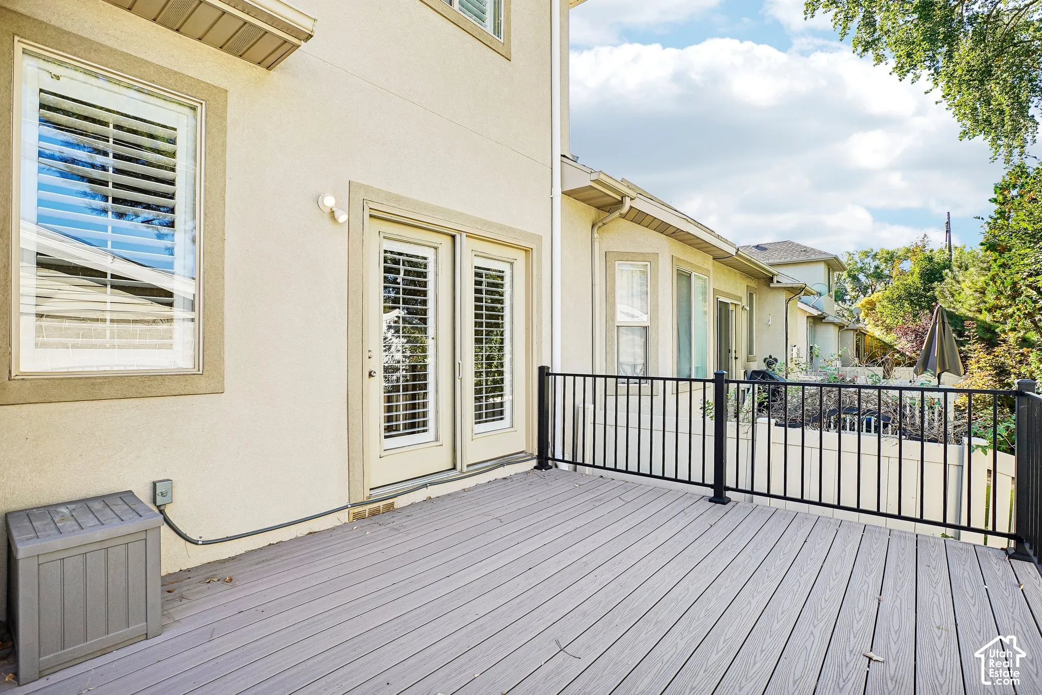 Expansive outdoor deck with composite decking and black metal railings