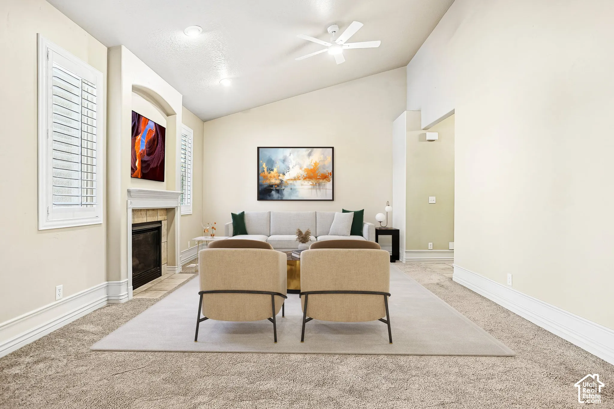Vaulted ceilings, recessed lighting, and a built-in fireplace with a stone surround