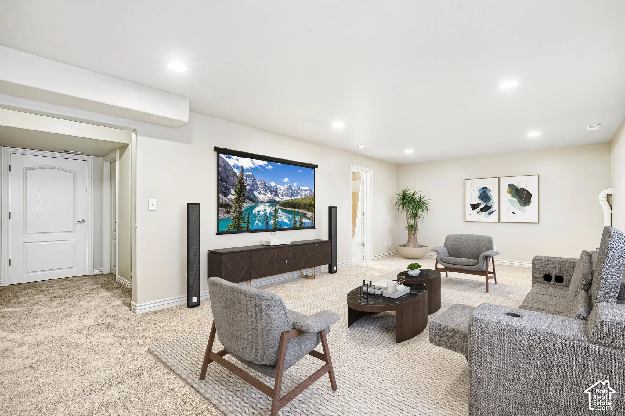Recessed lighting, light neutral wall color, carpeted flooring, built-in entertainment console, and solid panel interior door
