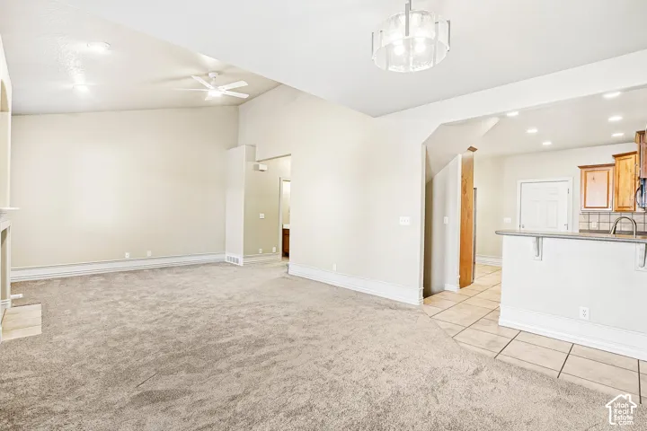 Vaulted ceiling with a ceiling fan and recessed lighting