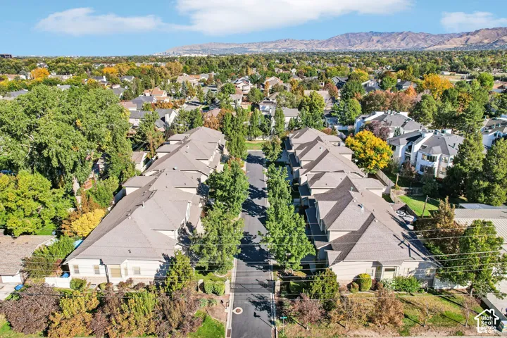 Residential community featuring multiple two-story structures with light-toned exteriors and gray roofing