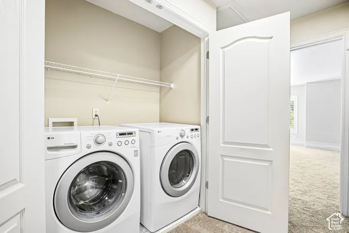 Dedicated laundry closet featuring a wire storage shelf and front-loading appliances