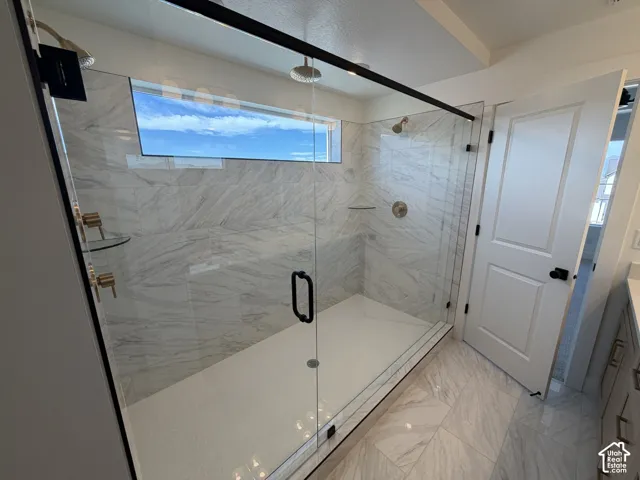 Walk-in shower with clear glass enclosure and black frame