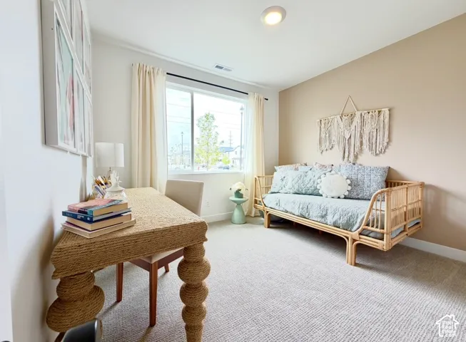 Recessed ceiling lighting, large window with natural light, neutral wall colors, and textured carpeting