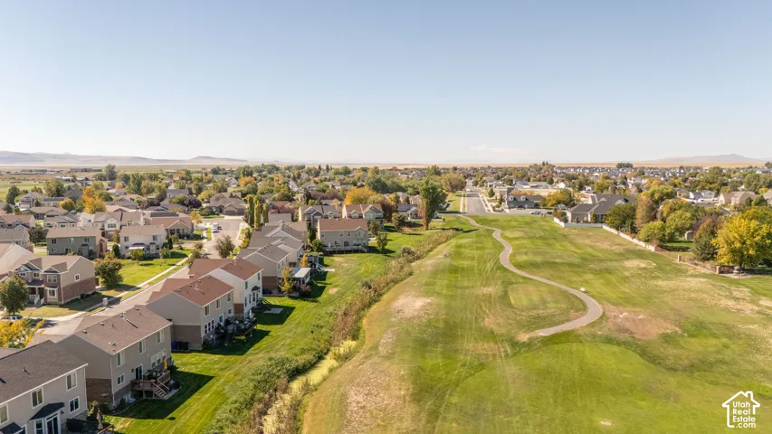 Expansive green space featuring a winding paved path