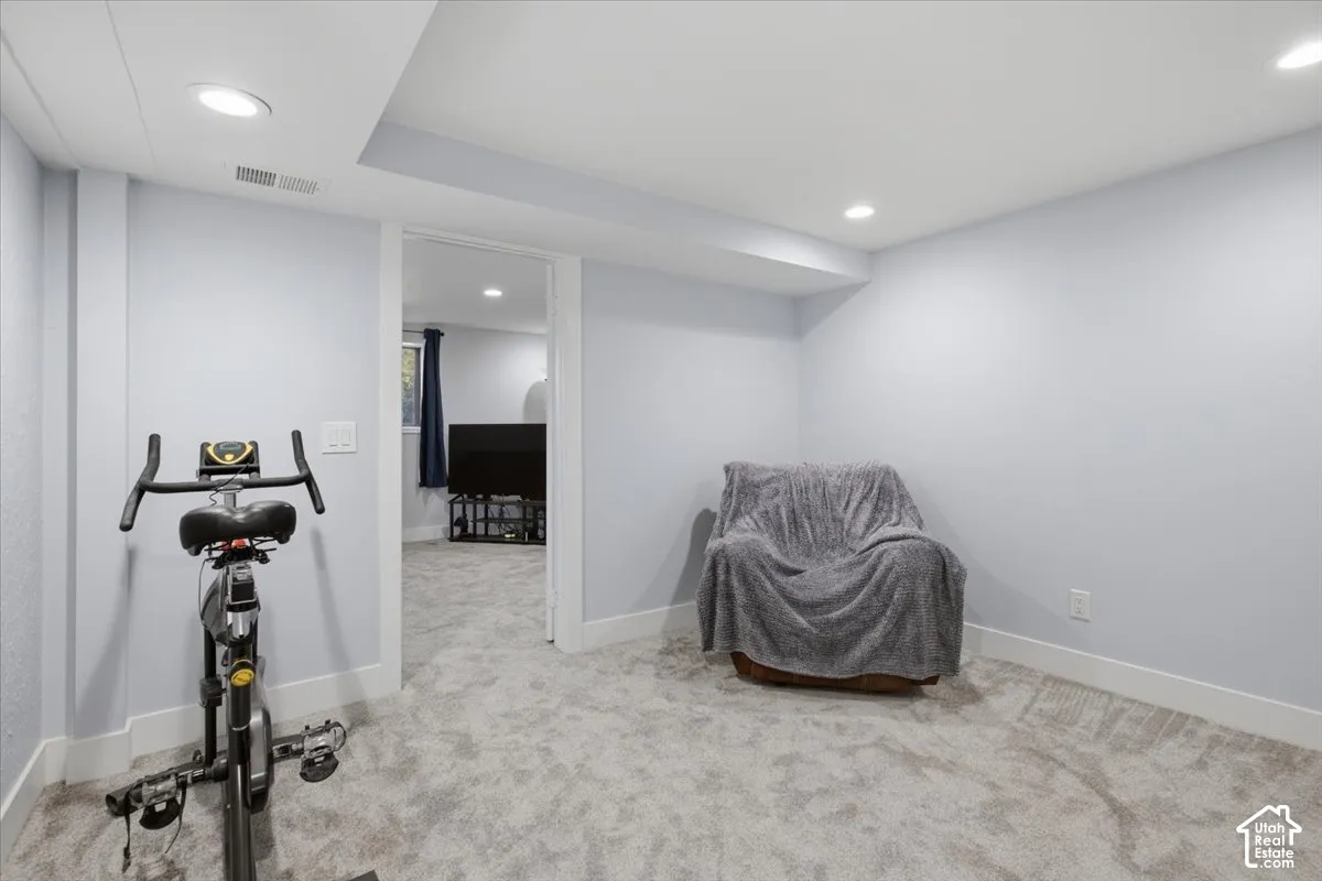 Recessed lighting, light gray wall finish, white trim, and gray carpeted flooring