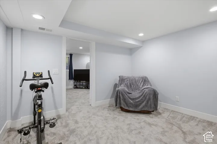 Recessed lighting, light gray wall finish, white trim, and gray carpeted flooring