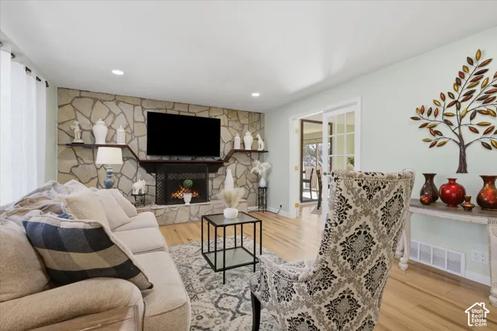 Stone-clad fireplace with built-in mantel and shelving