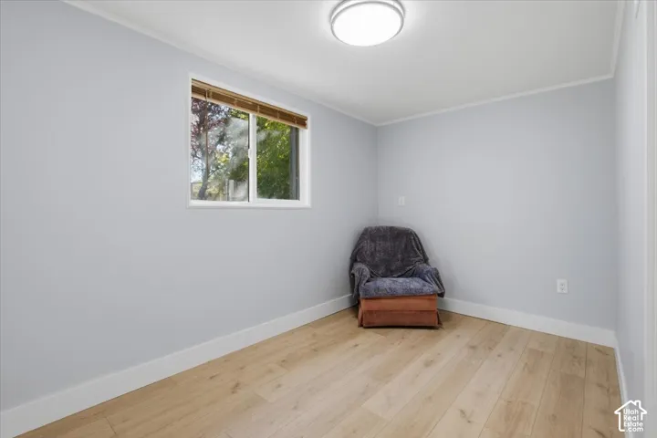 Wood-finish flooring, white trim, recessed lighting, and a white-framed window