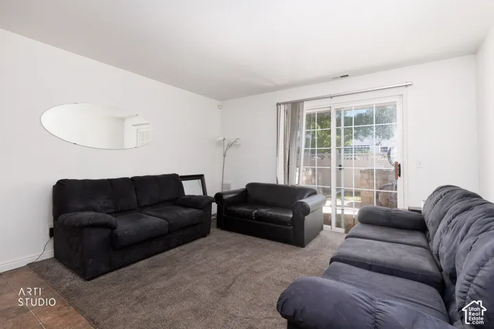 Sliding glass door, wall-to-wall carpeting, and white painted walls