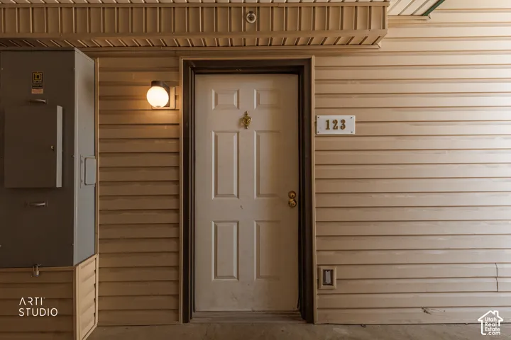 Entry door with decorative knocker and gold-tone hardware