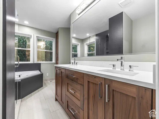 Dual wood-finish vanity with integrated sinks and chrome fixtures